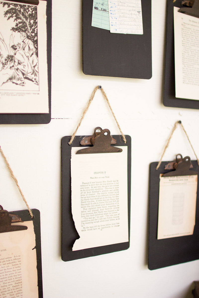black clip boards on a white wall