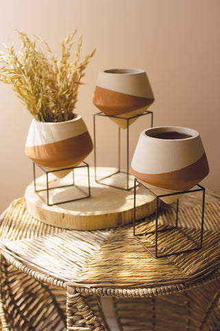 3 clay pots on metal stands